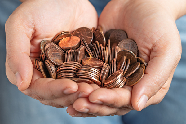 Person holding pennies