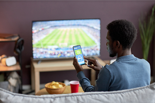 Person watching sports game and gambling