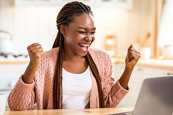Excited woman looking at computer