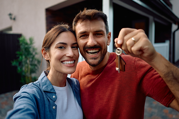 Couple at home with house keys in hand