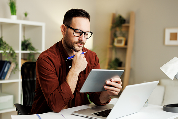 Male looking at tablet at home