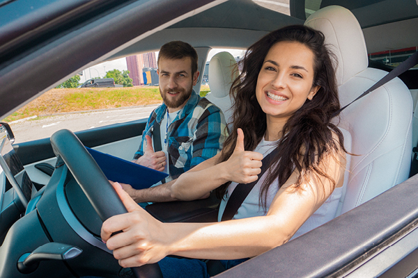 Couple in car giving thumbs up gesture