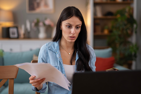 Woman confused looking at paperwork