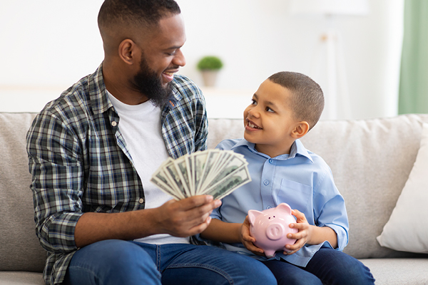 father and son learning about money