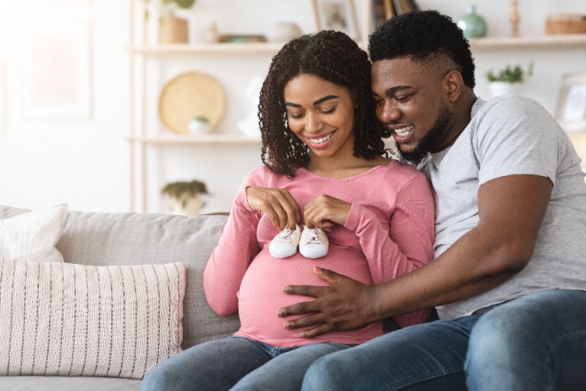 Pregnant couple with baby booties 