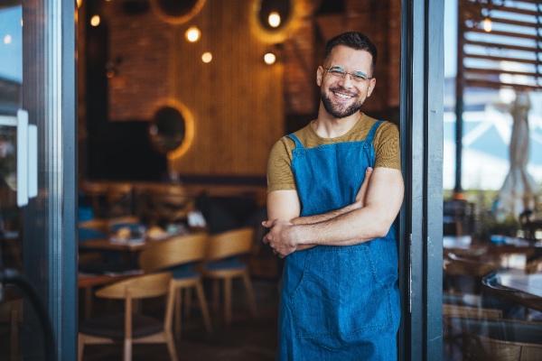 Young business owner standing in doorway