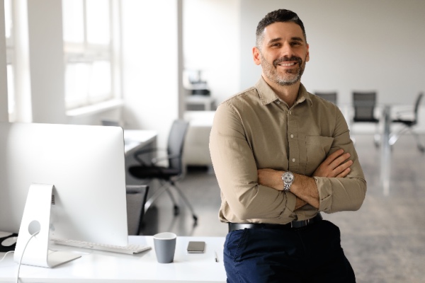 Man smiling and looking at the camera in his office 