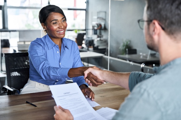Woman shaking hands with employer