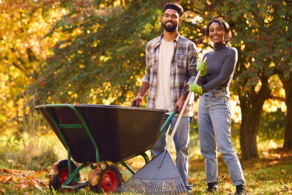 Couple doing yard work in fall