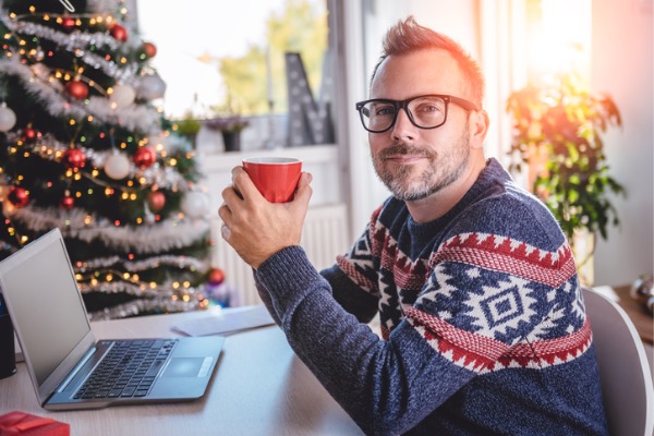 Man sitting at home with coffee and laptop