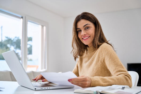 Woman sitting at table with computer 