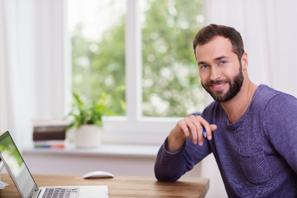 Man sitting at table with laptop