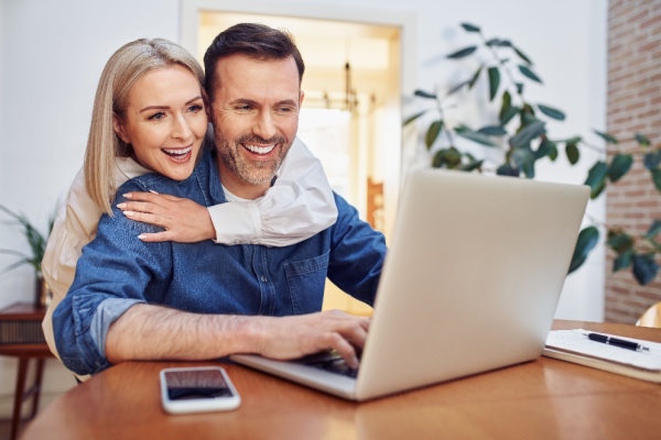 Couple looking at computer at home