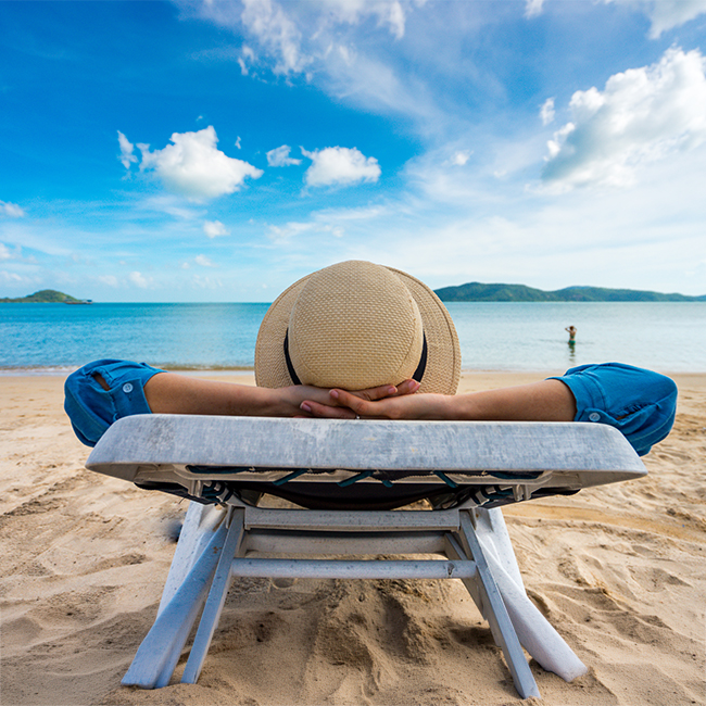 man relaxing sitting in beach chair on the shore