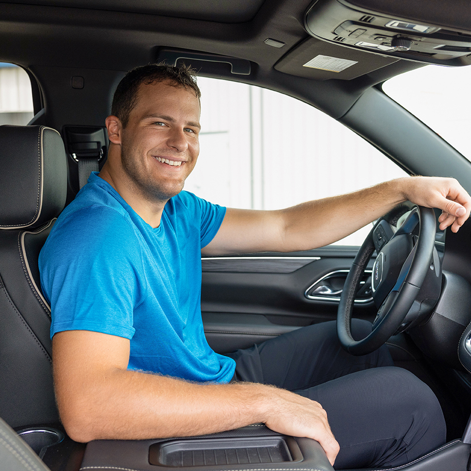 Family outside home near car